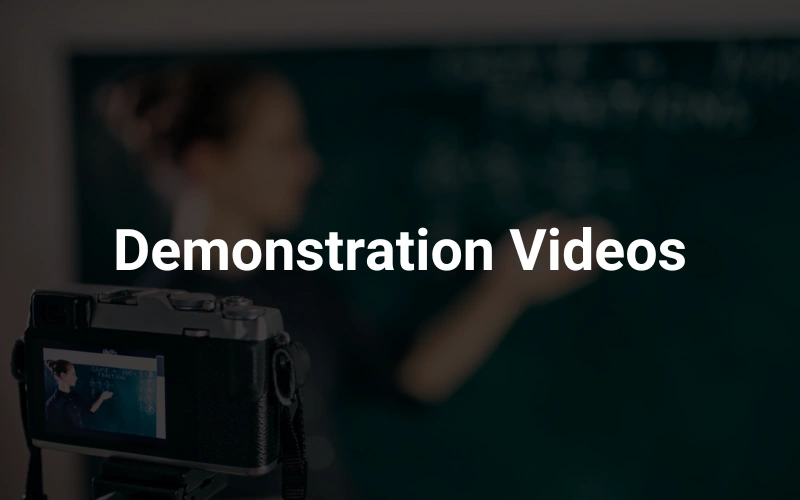 a camera sitting on top of a tripod in front of a chalkboard in the background, highlighting the text "Demonstration Videos."