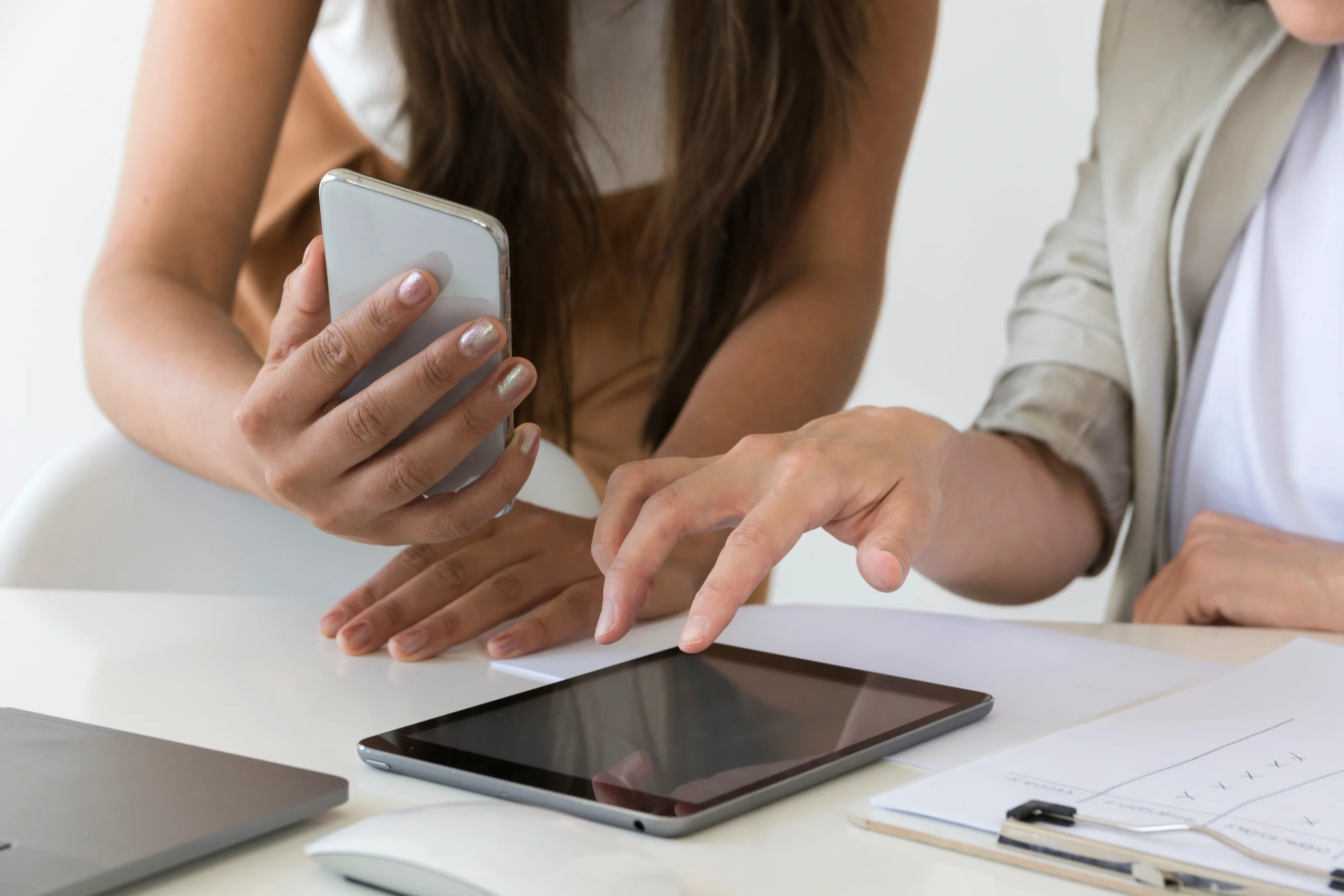 Two people collaborating on a digital project using a tablet and smartphone. Keywords: videographer, videography, digital marketing, Mumbai.