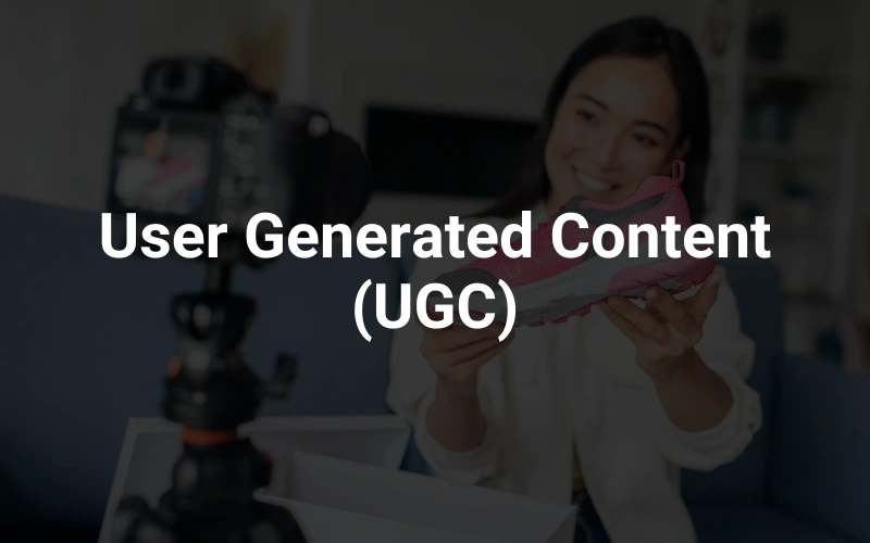 a woman holding a cell phone in front of a camera in the background, highlighting the text "User Generated Content (UGC)."